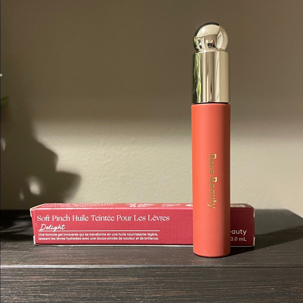 Rare Beauty Soft Pinch Tinted Lip Oil in Delight, a rose brown shade.